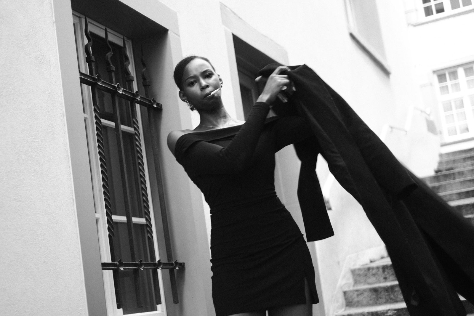 Black and white portrait by a doorway