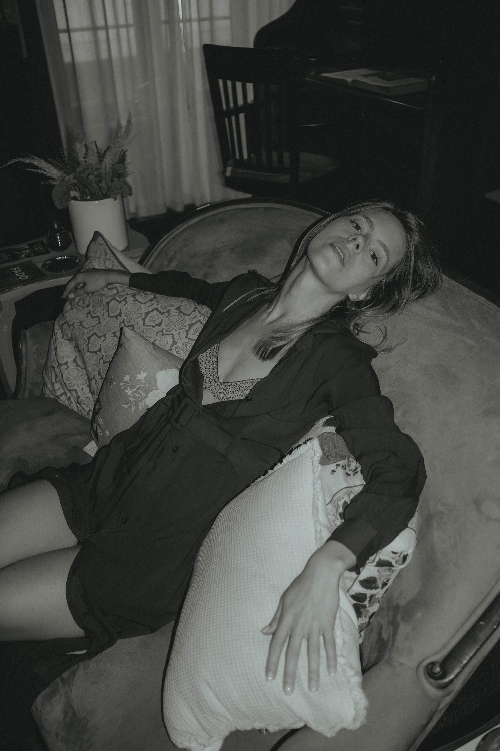 Black and white reclining portrait on a sofa