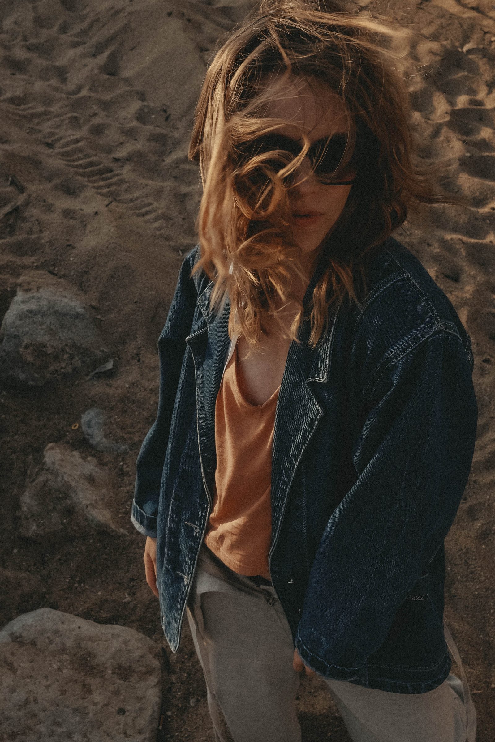 Portrait in a denim jacket, hair in the wind