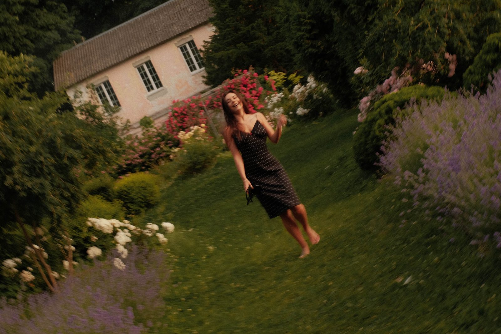 Woman in a garden among flowering shrubs