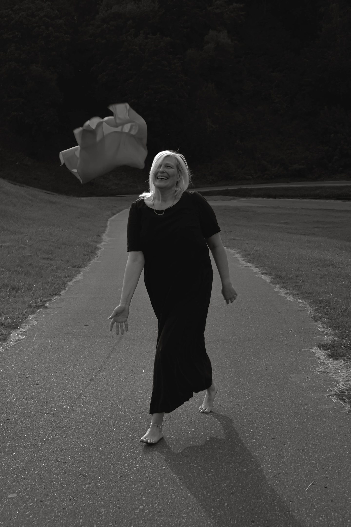 Black and white figure walking on a road
